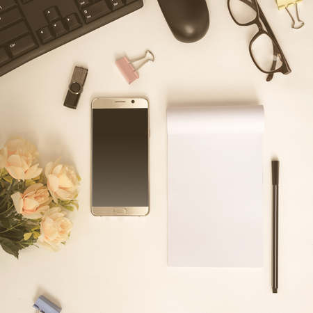 Flat lay office equipment on the desk with business workspace and vintage toneの写真素材