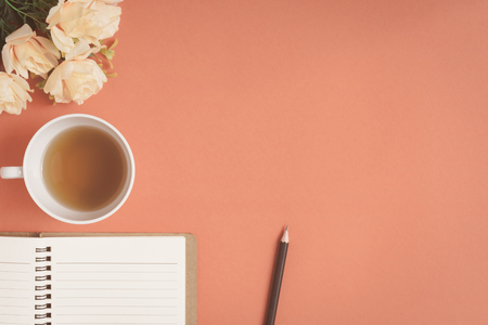 Flat lay Notebook and rose placed on a red desk with write text and vintage toneの写真素材