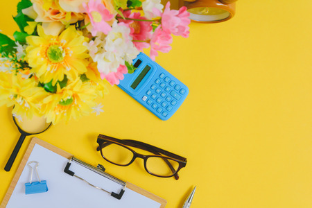 Office equipment on a yellow and golden paper desk with a business workspeac and color vividの写真素材