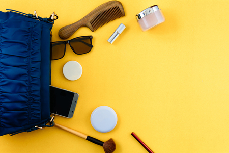 Flat lay set bag and Cosmetics on paper colorful for Women with Beauty Makeupの写真素材