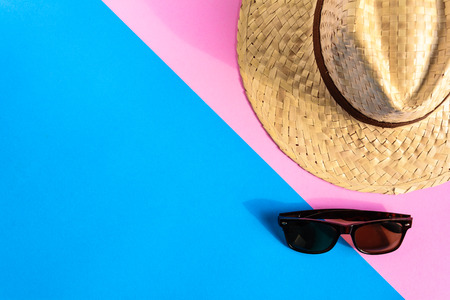 flat lay hat and sunglasses on colorful paper with travel and fashion styleの写真素材