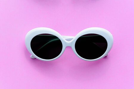 Flat lay fashion style sunglasses on colorful background with sun protectionの写真素材