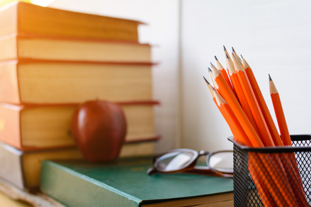 Books Pencil and glasses on a white wooden table and decorations With a room white wall wood .selective focusの写真素材