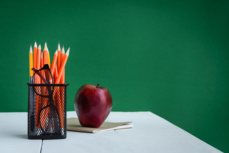 Books Pencil and apple on a white wooden table with skill learning .selective focusの写真素材