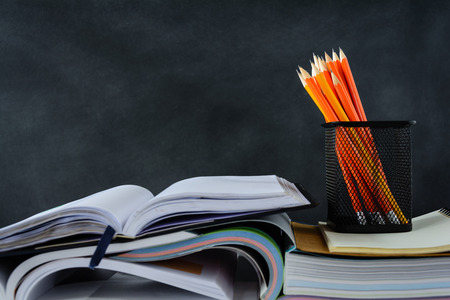 book and pencil on white table black board background with study and education concept.selective focusの写真素材