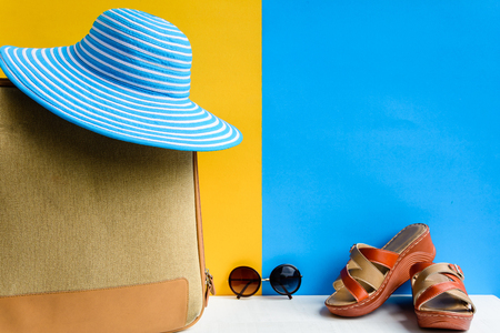 set travel and vacation with Blue hat sunglasses and bag orange shoe on wood table and colorful backgroundの写真素材