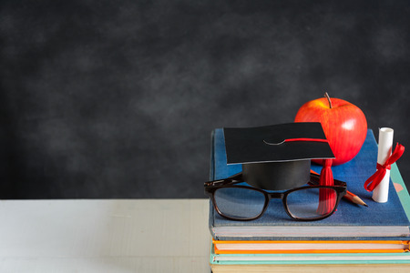Apple Knowledge Symbol and Pencil Books on the desk with board background.Education concept schoolの写真素材