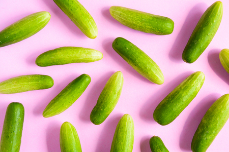 top view green cucumber and pink background with food health organicの写真素材