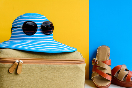 set travel and vacation with Blue hat sunglasses and bag orange shoe on wood table and colorful backgroundの写真素材