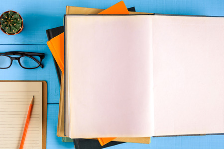 top view book mockup and pencil note on blue wood table with cactus decoration on deskの写真素材