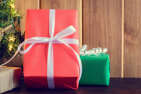 gifts and toys on wooden boards with Christmas holidays and happy smile kids.の写真素材