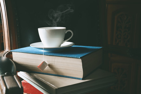 Book and tea on the desk with study and education concept. vintage toneの写真素材