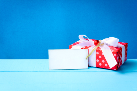 mock up white text label and gift boxes on the wood table with the holiday seasonの写真素材