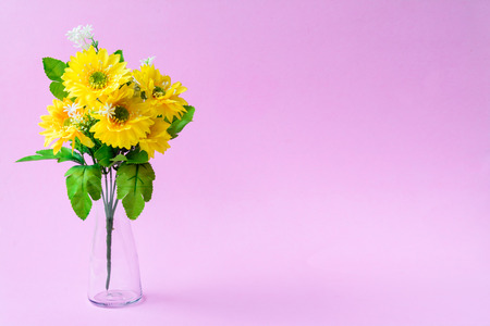 decorate flower in a vase on a blue table and a pink wall background with a color pastel style and text spaceの写真素材