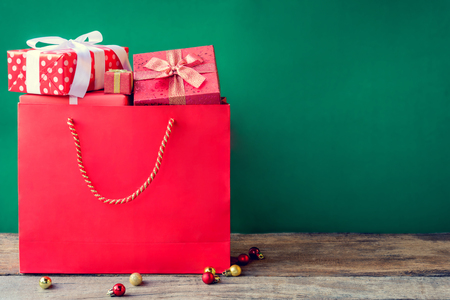 top view gift boxes in bag and shopping mall and green background with the holiday seasonの写真素材