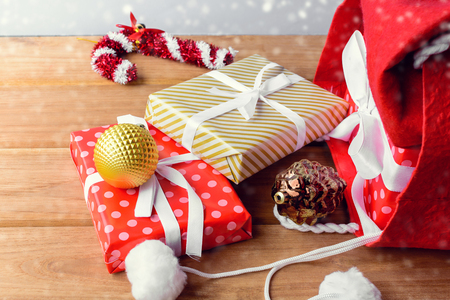 christmas and gift boxes in red bag and white background on wood table with the holiday season. shopping festival decoration

の写真素材