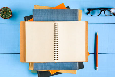 top view book mockup and pencil note on blue wood table with cactus decoration on deskの写真素材