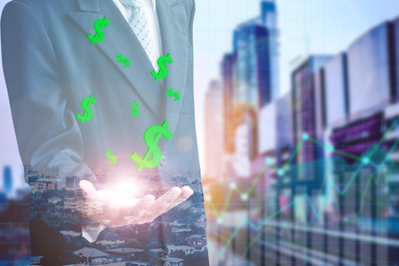 Finance and Investment concept.Money management and Financial chart.businessman in the city.exposure double people and buildingの写真素材