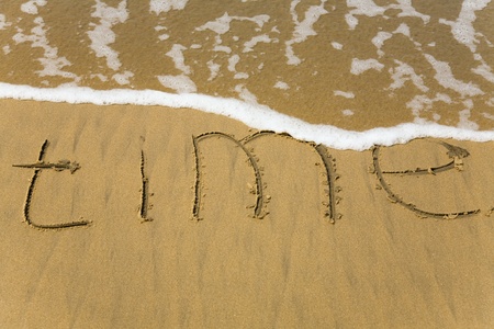 Handwriting word Time written  in the sandの写真素材