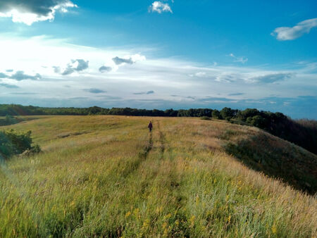 Man walking down country road in field,   Belgorod Oblast. Russia.の写真素材