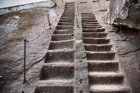 steps in stone with buddha  in Cave temple in Milkirigala near Tangalle, Sri Lanka. Cave temple has five caves under a vast overhanging rock and dates back to the first century BCのeditorial素材