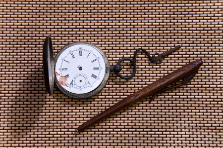 old pocket watch with key  and penの写真素材