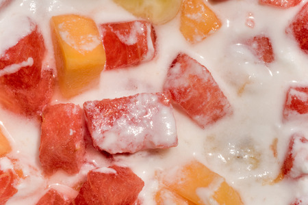 Fresh mixed fruit salad with banana, papaya,watermelon in milkの写真素材