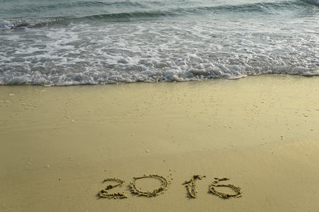 new year numbers 2015 and 2016  drawings in the sand on the beach
