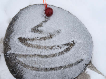 Christmas background with Christmas tree and red ball on snowの写真素材