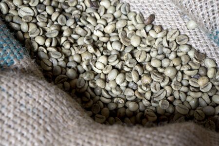 Green coffee bean raw in sack with scoopの写真素材