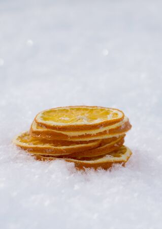 Merry Christmas and  New Year greeting card with dry orange, Clementines tangerines on snow as backgroundの写真素材