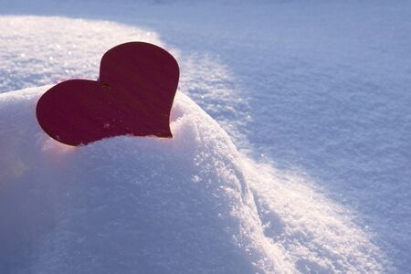 Valentine's Day background with  Frozen beautiful red heart in snowの写真素材