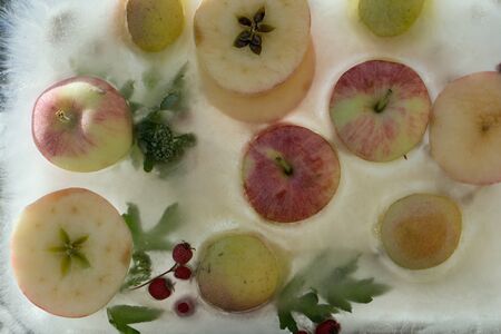 Background   fresh season apple   in ice   cube with air bubblesの写真素材