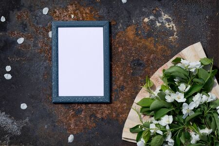 Creative top view apple tree blooming flowers brunch frame, paper fan on  rustic wooden   background with copy space in minimal style, template for lettering, text or your designの写真素材