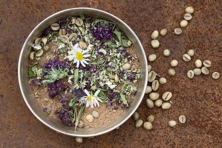 scrub of natural ingredients , flowers  on iron rustic backgroundの写真素材