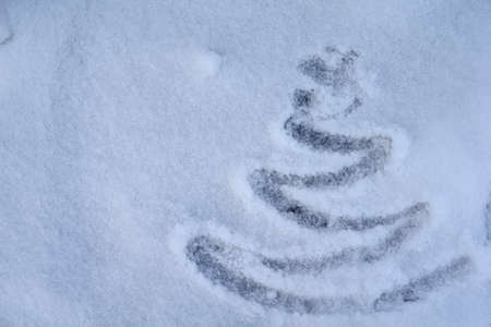 Christmas tree on background with snow. Christmas and New year decorations or greeting card.