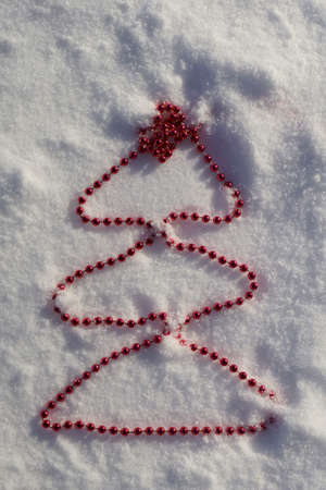 Christmas tree on background with snow. Christmas and New year decorations or greeting cardの写真素材