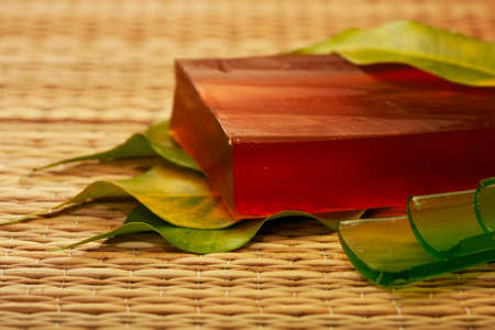 bar of natural handmade soap from indian natural ingredients with green leaf.の写真素材