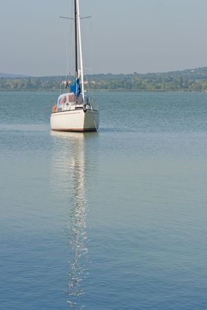 small yacht anchored in a lakeの写真素材