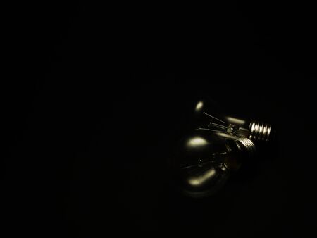 Two incandescent lamps on a black backgroundの写真素材