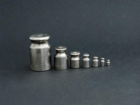 Metal weights for scales on a black backgroundの写真素材