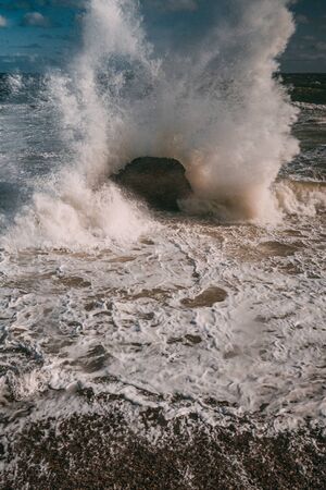 waves on the sea beach on a sunny dayの写真素材