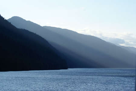 Low Alaskain Sun lights these coastal mountainsの写真素材