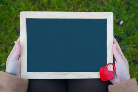 Table for Valentine's Day. Heart shaped red padlock on blackboardの写真素材
