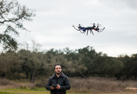 A man Operating The Drone By Remote Control In The Parkの写真素材