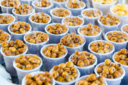 delicious tiger nuts in plastic glasses watered with water.の写真素材