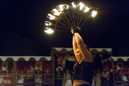 Alburquerque, Spain - august 19, 2017. Female fire show performer at night participing in festival medieval in Alburquerqueのeditorial素材