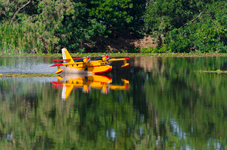 A floating Radio controlled model hydroplane speeds up to take off on Guadiana river, Badajozの写真素材