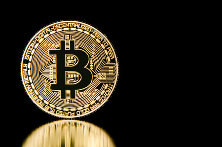 Bitcoin on black background with reflection