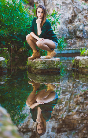 Beautiful young woman posing in lakeの写真素材